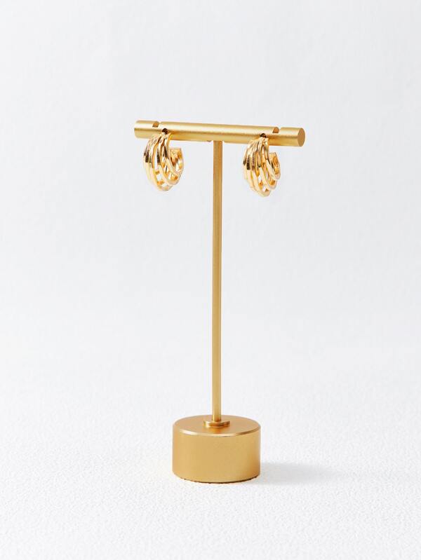 Gold hoop earrings on stand display