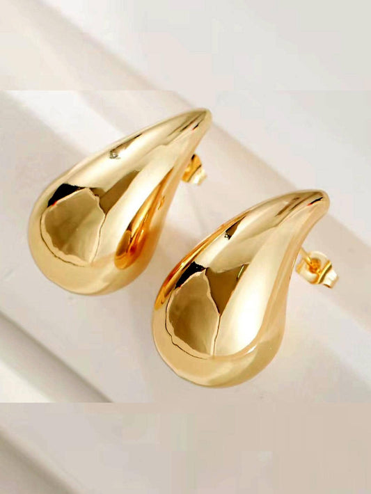 Gold teardrop fashion earrings on white background – Gillian & Co